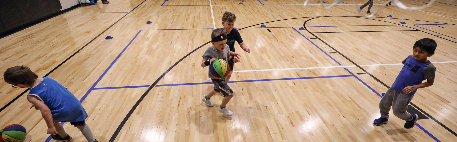Kids playing basketball at the Plymouth Community Center